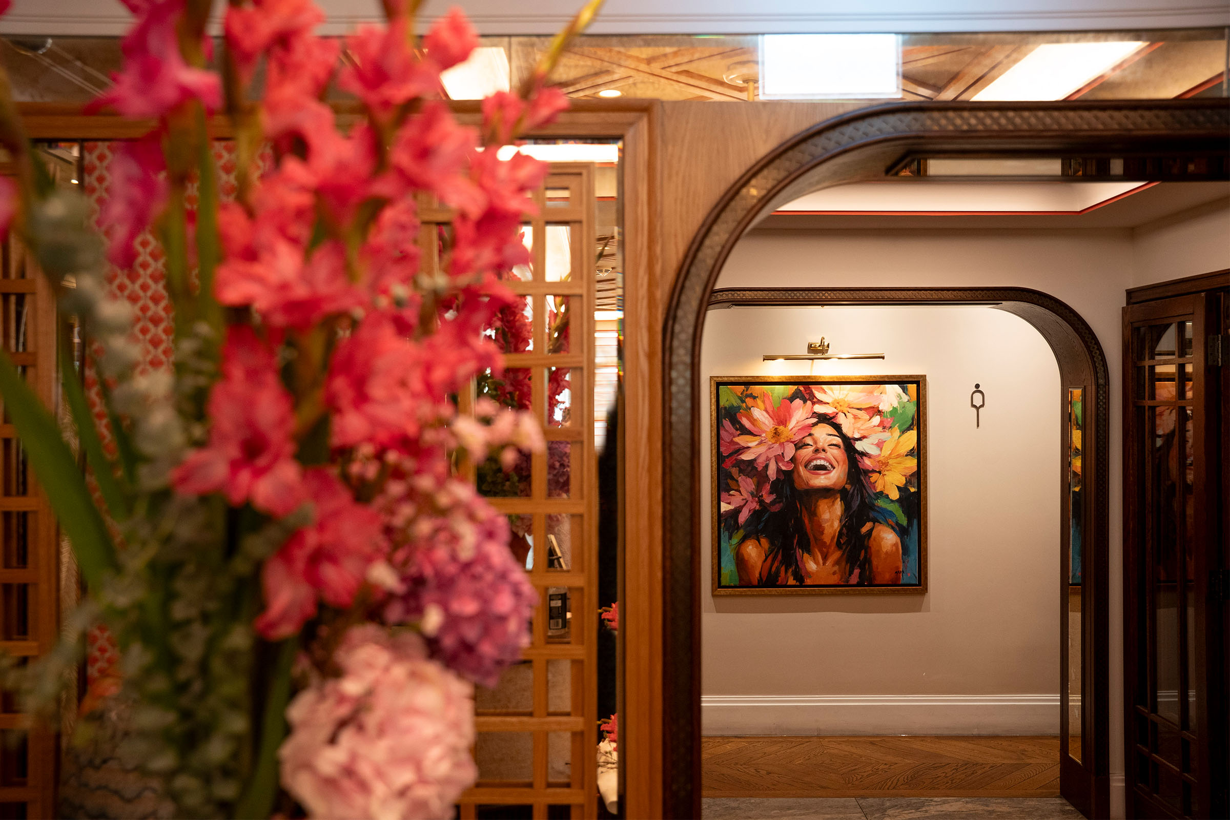 Gabrielle Malak floral portrait set into an archway at La Maison Ani